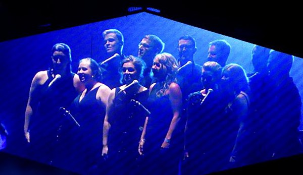 Photo by David Thompson Performers from VocalEssence appear on one of the screens at TCF Stadium during Wednesday night's performance.