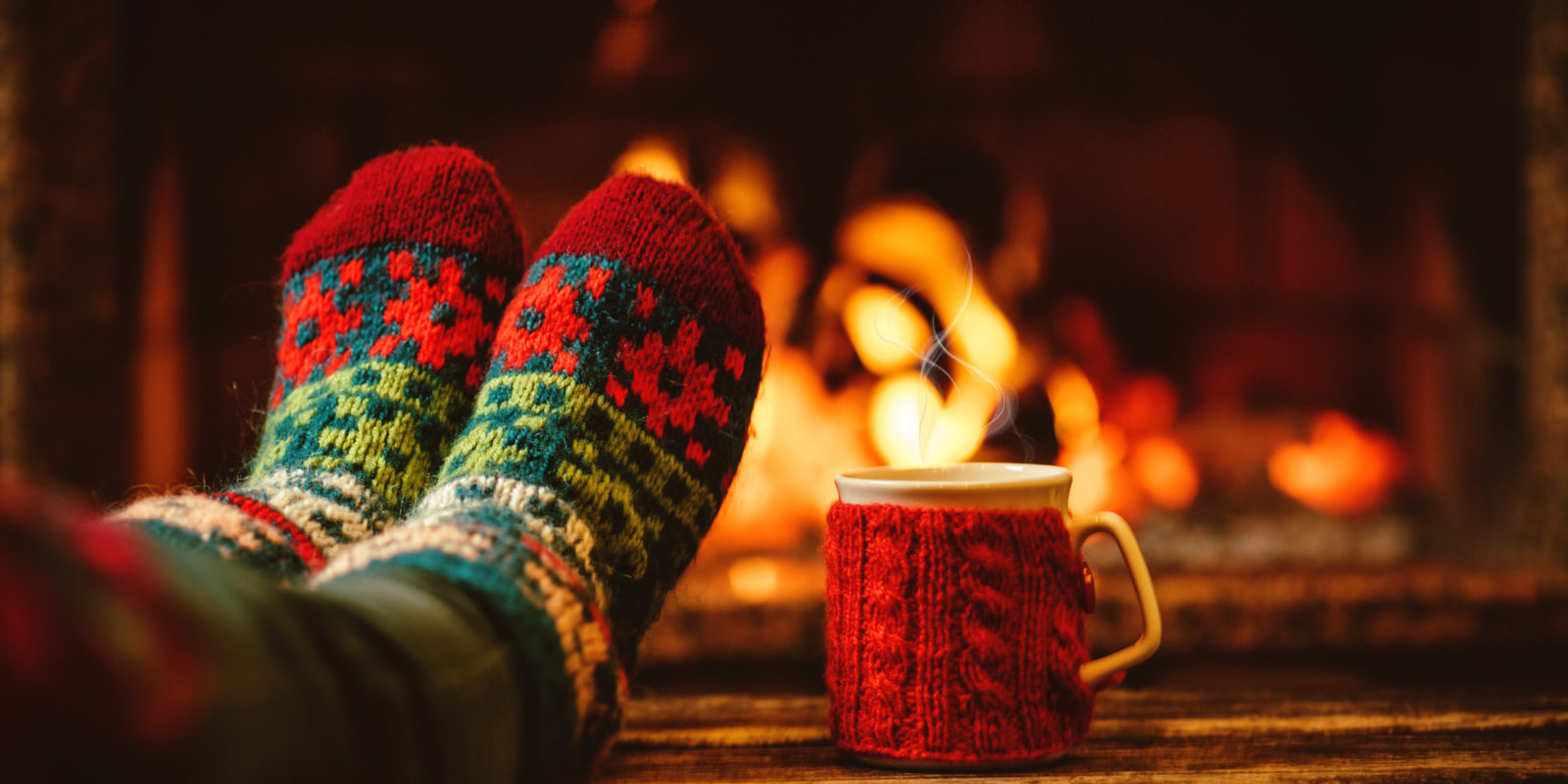 Feet in front of a fire with mug