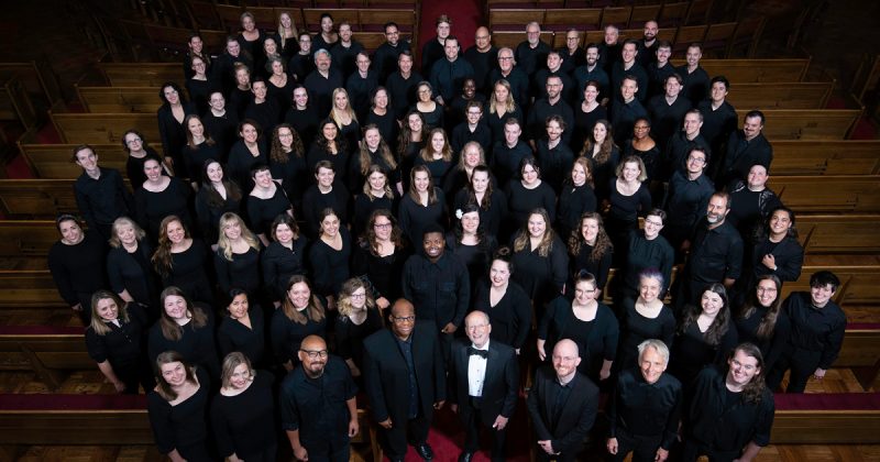 Members of the VocalEssence Chorus wearing black and looking at the camera. Photo credit: Bruce Silcox