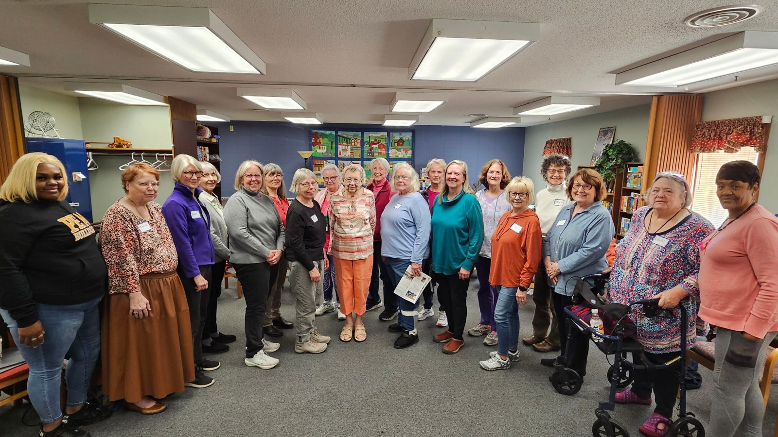 Members of the Keystone Community Singers standing in a curved row looking at the camera.