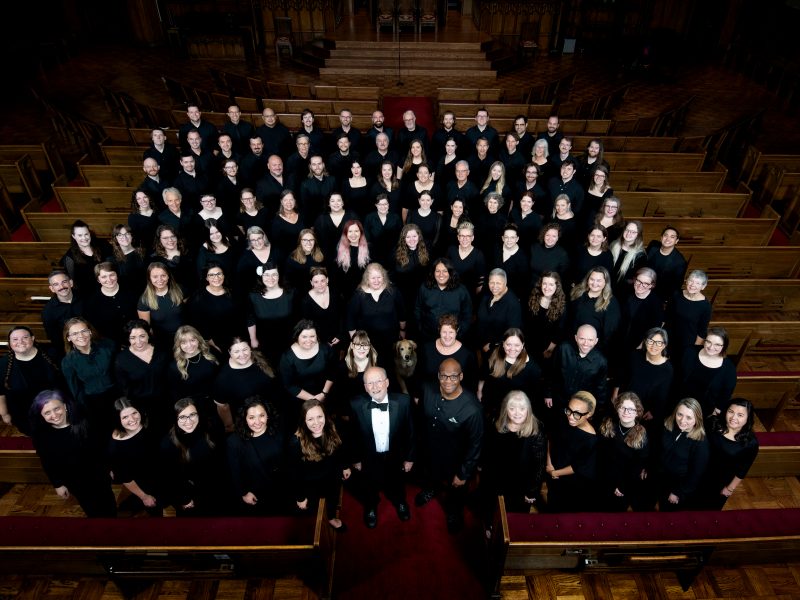 VocalEssence Chorus members wearing black pose for a photo. Photo Credit: Bruce Silcox
