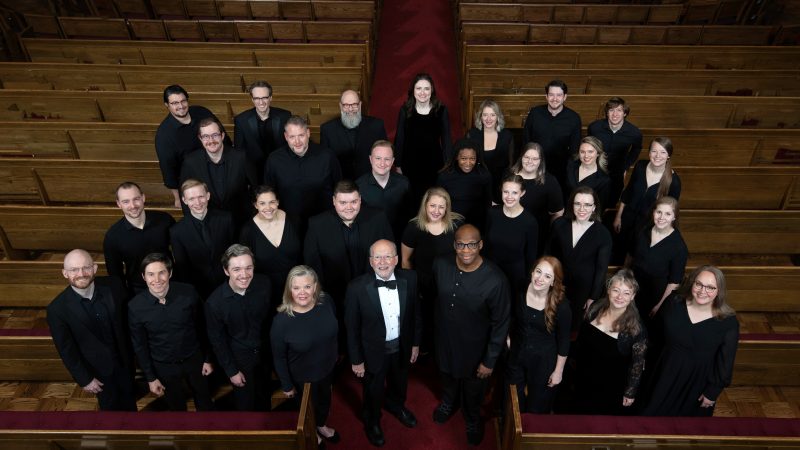 VocalEssence Ensemble Singers wearing black pose for a photo. Photo Credit: Bruce Silcox