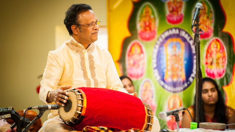 Thanjavur K. Murugaboopathi sits playing the mridangam, a South Indian hand drum. Photo Credit: ReyMash Photography