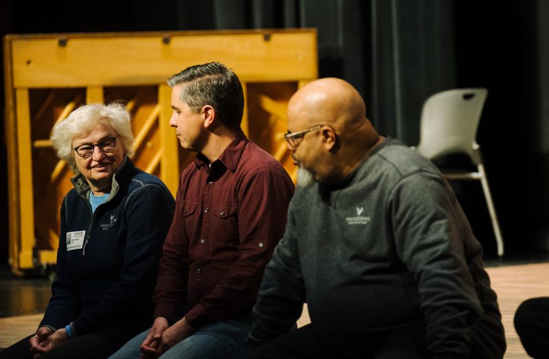 Three people sitting in front of a piano on a stage. Photo credit: Laura Alpizar