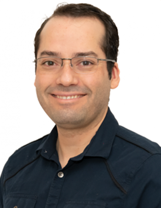 Image of person with short dark hair wearing glasses and black button down shirt.