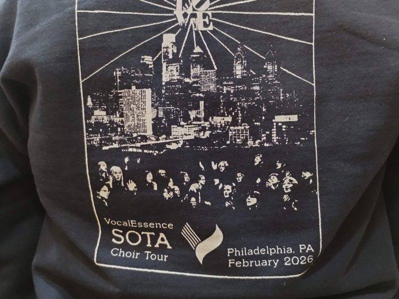 Image of he LOVE sculpture, below it is the Philadelphia skyline with images of faces below it, and the VocalEssence "V".