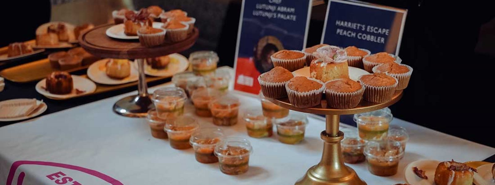 A table displays pastries and baked goods from a local Black chef at the 2025 Feeding Our Souls: The Essence of Juneteenth Joy.